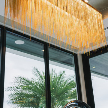 Coastal Opulence: Chandelier Close-Up with Backyard Water View