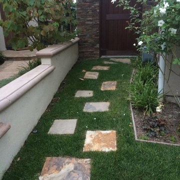 Sandstone squares lead to the side yard