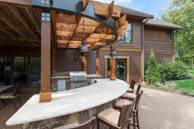 Patio kitchen - backyard patio kitchen idea in Kansas City with a pergola