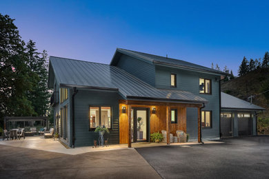 Trendy blue two-story concrete fiberboard and clapboard exterior home photo in Portland with a metal roof and a gray roof