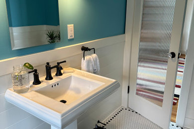 Large transitional mosaic tile floor, white floor, single-sink and wainscoting bathroom photo in Portland with a two-piece toilet, blue walls, a pedestal sink and a niche