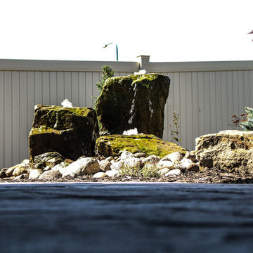 Moss Covered Bubbling Boulder Amidst Fine Rock Formation