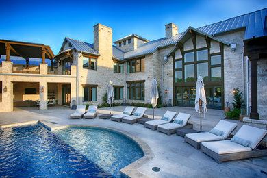 Transitional beige two-story stone gable roof idea in Dallas