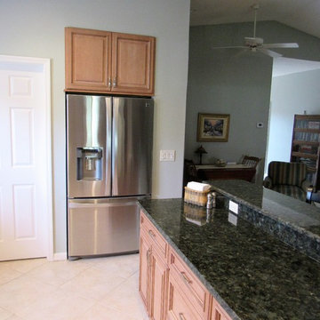 Galaxy Pecan cabinets with peacock green granite