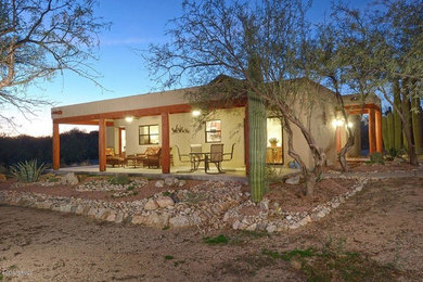 Mid-sized southwest backyard concrete paver patio photo in Phoenix with a roof extension