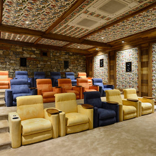 Inspiration for a large timeless carpeted home theater remodel in Mumbai with a projector screen