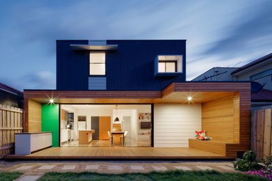 This is an example of a small contemporary two-storey black exterior in Melbourne with metal siding and a flat roof.