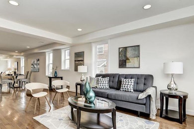 Inspiration for a mid-sized transitional open concept medium tone wood floor and beige floor family room remodel in DC Metro with white walls