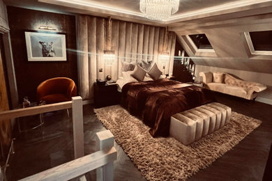 Large modern master bedroom in Kent with beige walls, dark hardwood flooring, brown floors, a drop ceiling, wallpapered walls and feature lighting.