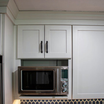 White Kitchen with Blue Tiled Backsplash and Two Tier Island