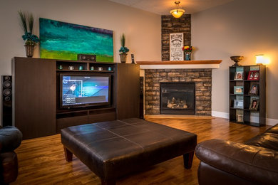 This is an example of a mid-sized transitional enclosed living room in Calgary with beige walls, a concealed tv, dark hardwood floors, a corner fireplace, a stone fireplace surround and brown floor.