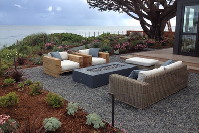 This is an example of a mid-sized beach style backyard full sun xeriscape in San Francisco with gravel.