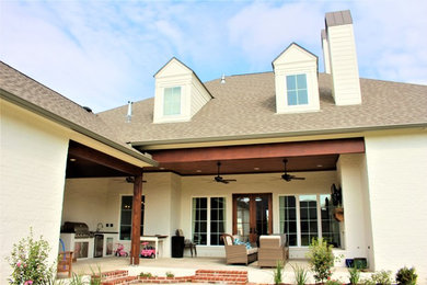 Mid-sized classic concrete porch idea in New Orleans with a roof extension