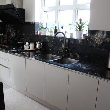 Elegant Modern Kitchen with Black Granite Island by Kudos Interior Designs