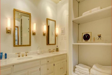 Inspiration for a transitional master white tile and subway tile ceramic tile and beige floor bathroom remodel in Austin with raised-panel cabinets, white cabinets, white walls, an undermount sink, quartzite countertops and a hinged shower door