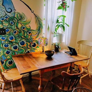 Dining nook with peacock mural, vintage furniture, art deco stained glass lamp