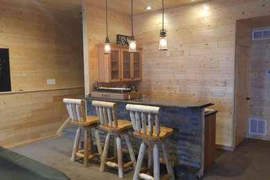 Mid-sized mountain style single-wall vinyl floor seated home bar photo in Other with light wood cabinets, tile countertops and glass-front cabinets
