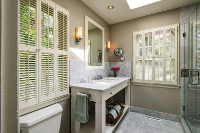 Small transitional gray tile and stone tile marble floor alcove shower photo in Chicago with an undermount sink, shaker cabinets, beige cabinets, marble countertops, a two-piece toilet and beige walls