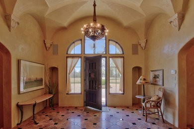 Inspiration for a large eclectic porcelain tile and beige floor entryway remodel in Nashville with beige walls and a dark wood front door