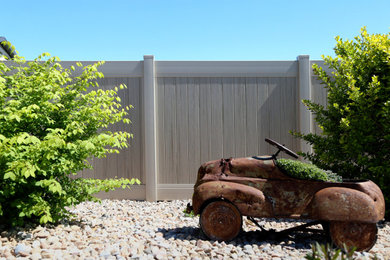 This is an example of a large full sun backyard vinyl fence landscaping in Boise for summer.