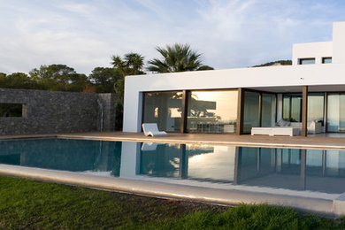 Large contemporary gray two-story stucco flat roof idea in Other