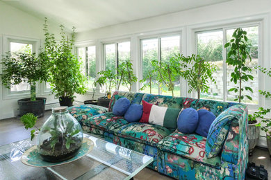 Sunroom - mid-sized medium tone wood floor and beige floor sunroom idea in Newark with a standard ceiling