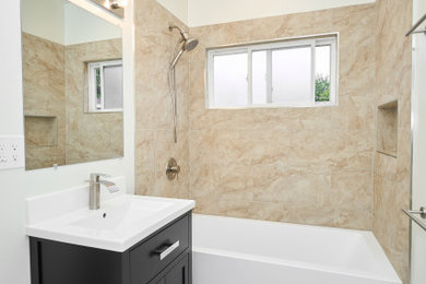 Example of a mid-sized arts and crafts 3/4 ceramic tile, gray floor and single-sink bathroom design in Los Angeles with shaker cabinets, black cabinets, white walls, a drop-in sink, white countertops and a freestanding vanity