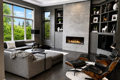 Example of a large minimalist black floor, dark wood floor, coffered ceiling and wall paneling family room design in Seattle with brown walls, a ribbon fireplace, a stone fireplace and a media wall