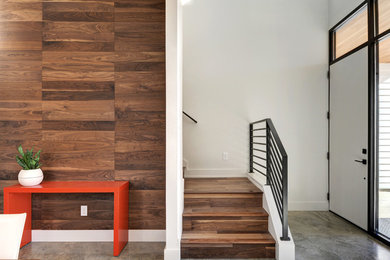 Entryway - country concrete floor entryway idea in Austin with white walls and a white front door