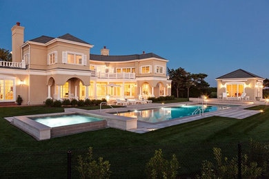 Inspiration for a huge backyard rectangular hot tub remodel in Boston