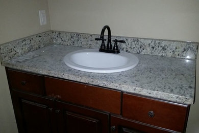 Bathroom - traditional bathroom idea in Birmingham with dark wood cabinets, beige walls and a console sink