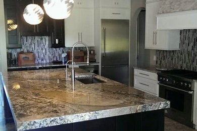 Large trendy l-shaped gray floor open concept kitchen photo in Miami with an undermount sink, shaker cabinets, white cabinets, multicolored backsplash, matchstick tile backsplash, stainless steel appliances and an island