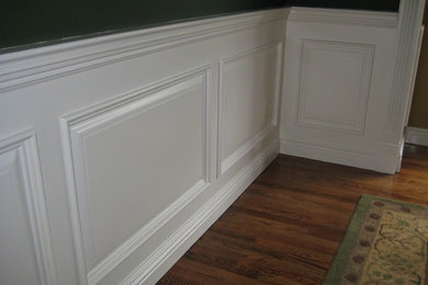 Elegant dark wood floor and beige floor hallway photo in New York with multicolored walls