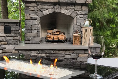 Mountain style backyard stamped concrete patio kitchen photo in Other