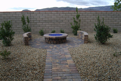 Mid-sized arts and crafts backyard brick patio photo in Las Vegas with a fire pit and no cover