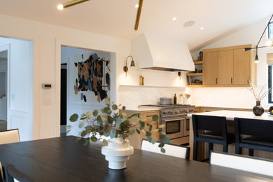 Example of a large classic u-shaped eat-in kitchen design in Portland with an island