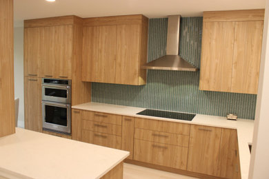 Inspiration for a mid-sized mid-century modern l-shaped porcelain tile and beige floor eat-in kitchen remodel in Tampa with an undermount sink, flat-panel cabinets, light wood cabinets, quartz countertops, blue backsplash, mosaic tile backsplash, stainless steel appliances, an island and white countertops