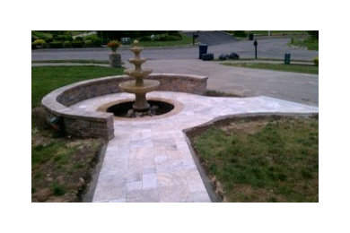 Travertine Entry way with a Fountain and Sitting Wall