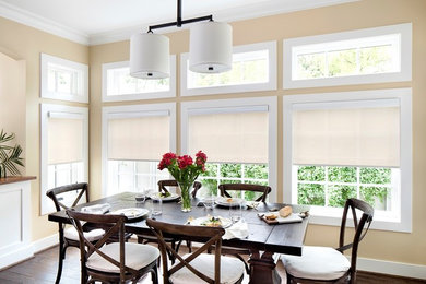 This is an example of a transitional open plan dining in DC Metro with beige walls, dark hardwood floors and brown floor.