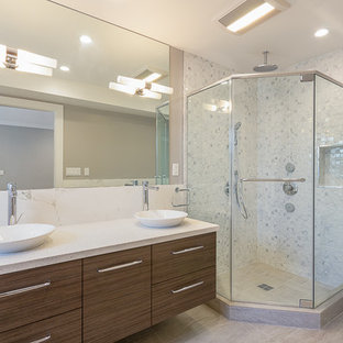 Inspiration for a medium sized contemporary ensuite bathroom in San Francisco with a vessel sink, flat-panel cabinets, medium wood cabinets, a corner shower, a one-piece toilet, grey walls, ceramic flooring, grey tiles, white tiles, porcelain tiles, engineered stone worktops, grey floors, a hinged door and a freestanding bath.