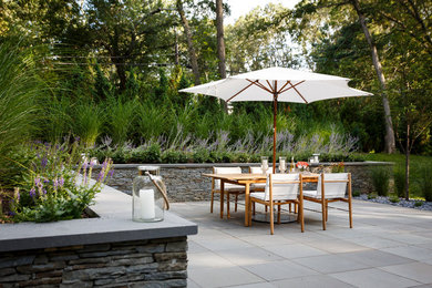 Transitional concrete paver patio photo in Providence with no cover