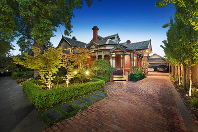 Design ideas for a victorian two-storey concrete red exterior in Melbourne with a gable roof.