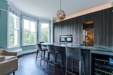 Inspiration for a large modern single-wall kitchen/diner in Manchester with stainless steel appliances and an island.