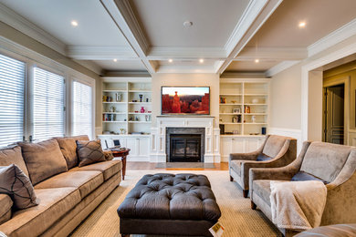 This is an example of a contemporary living room in Boston with medium hardwood floors, a standard fireplace, a wood fireplace surround and a wall-mounted tv.