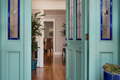 Mid-sized beach style light wood floor entryway photo in San Diego with white walls and a blue front door