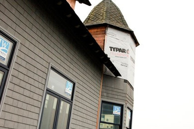 Example of a classic gray wood exterior home design in Seattle