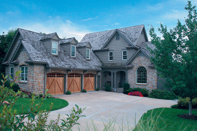 Inspiration for a large timeless attached three-car garage remodel in Denver