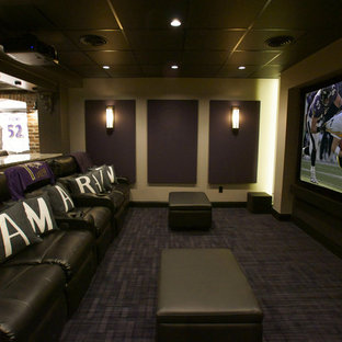 This is an example of a small classic open plan home cinema in Baltimore with beige walls, carpet, a projector screen and black floors.