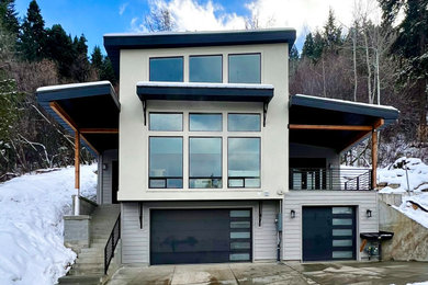 Example of a mid-sized minimalist three-story stucco and clapboard house exterior design in Salt Lake City