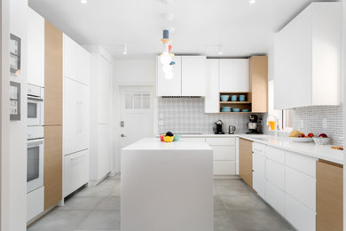This is an example of a mid-sized scandinavian l-shaped separate kitchen in Salt Lake City with an undermount sink, flat-panel cabinets, white cabinets, quartz benchtops, white splashback, ceramic splashback, white appliances, cement tiles, with island, grey floor and yellow benchtop.